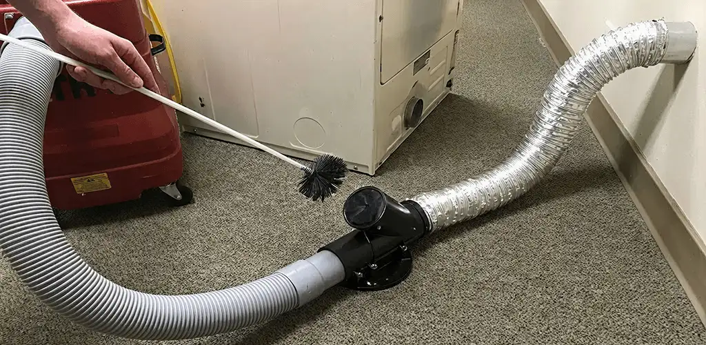 Dryer vent cleaning service removing lint from a dryer duct connection in Savannah, GA