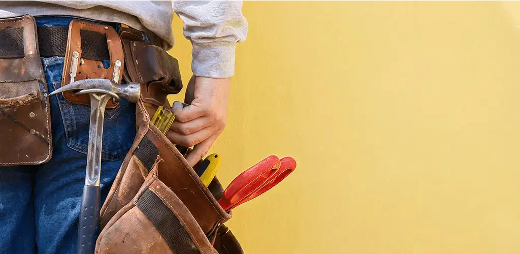 Handyman with tool belt ready for home repairs and maintenance in Savannah, GA