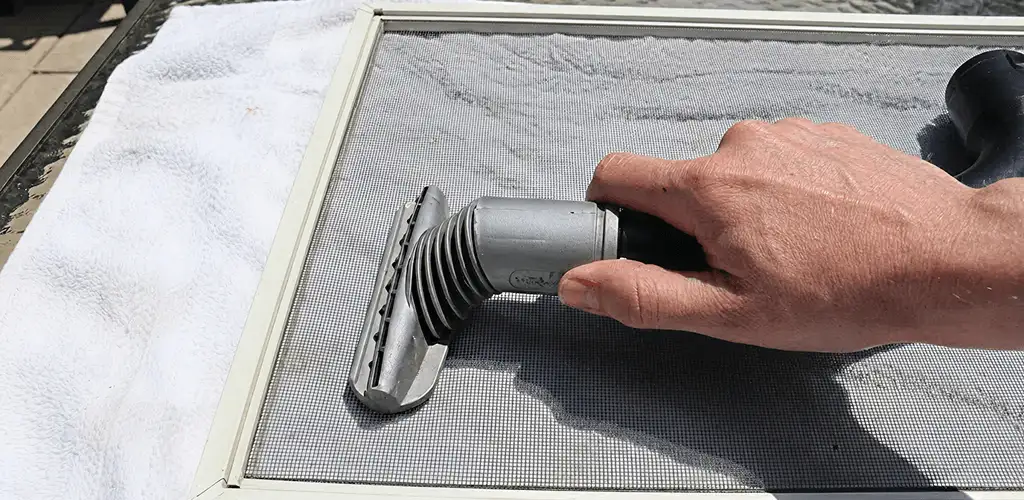 Window screen repair cleaning and fixing a damaged screen mesh in Savannah, GA