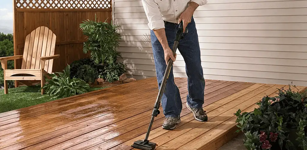 Deck staining service applying stain to a backyard wood deck in Savannah, GA